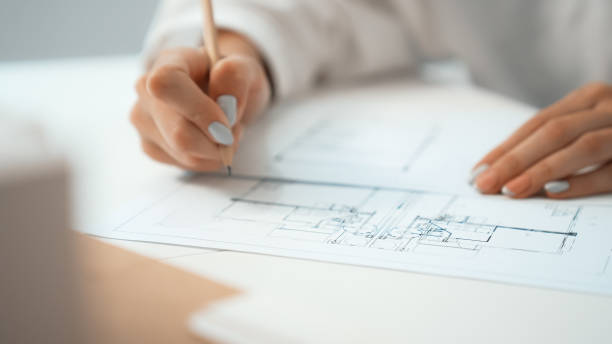 istock Closeup of professional female engineer hand drawing blueprint. Immaculate. 1994348103