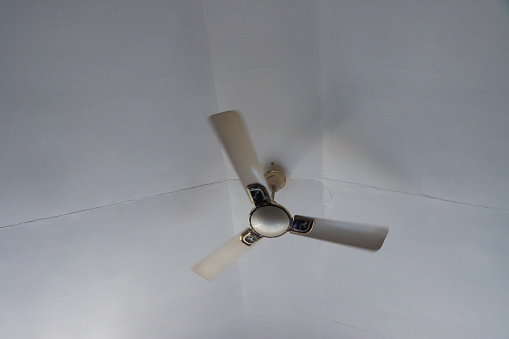 Low Angle View of a rustic ceiling fan in an old house
