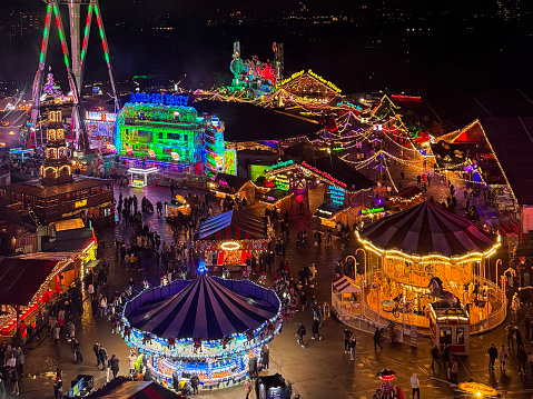Hyde Park Winter Wonderland, Westminster, Greater London, England, UK - December 13, 2023: Stock photo showing aerial view of Hyde Park Winter Wonderland, Christmas themed amusement park fairground viewed from the top of a Ferris wheel.