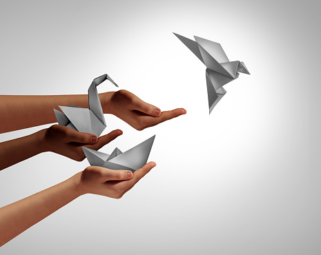 Leadership And Development concept as a symbol for innovation and progress as an icon of improvement as people with evolving origami sculptures representing creative technology advancement.