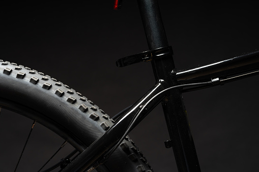 Close up photo of a bicycle against black background