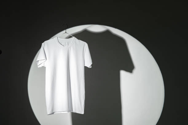istock Blank T-shirt hanging in a spotlight in studio 1994419784