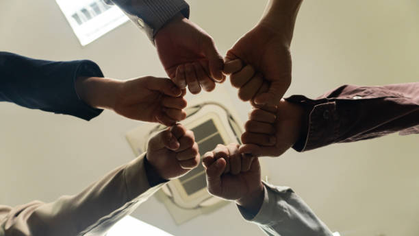 istock Business people, hands and together with team and support, collaboration and team building low angle. Business meeting, connection with trust, community and solidarity with teamwork and motivation 1994424533