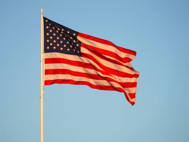 Manhattan building exterior with American flags outside.