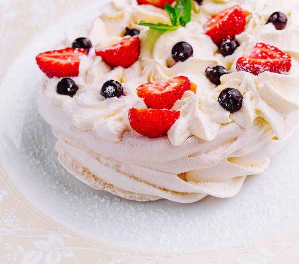istock Pavlova cakes with cream and fresh berries on plate 1994427184