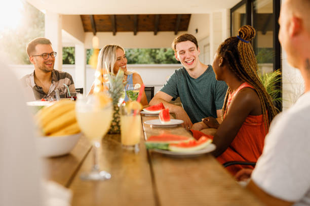 istock Young happy friends talking during social gathering on a patio. 1994443464