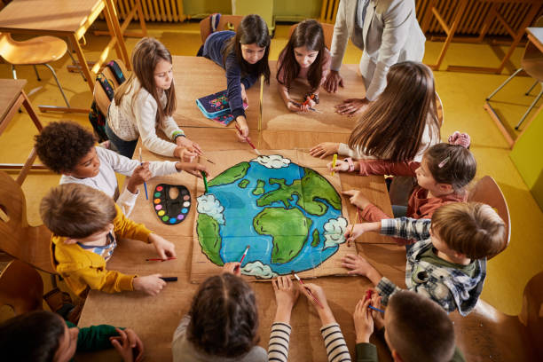 istock Above view of students drawing a planet on art class at elementary school. 1994445045