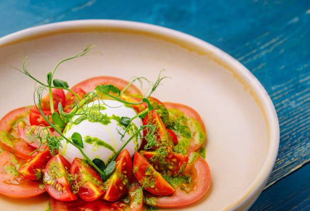 istock Burrata cheese and tomatoes salad served on plate 1994451369