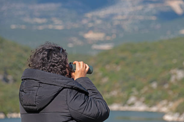 istock A woman birdwatching with binoculars. 1994463596