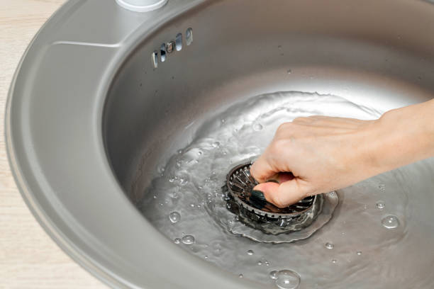 istock woman's hand opens the drain plug in the sink 1994472005