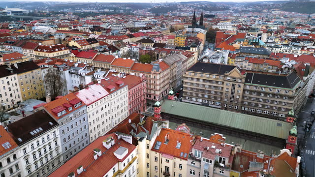 Aerial drone view of Prague city with lots of buildings with red roofs. Basilica of St. Peter and St. Paul in background. Czech Republic