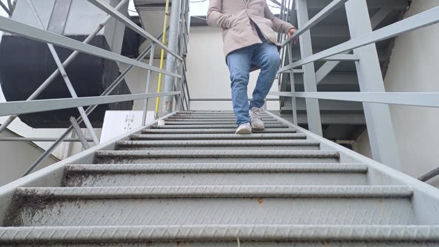 Man walking down a set of stairs in a city