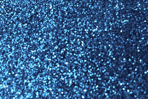 Blue bokeh glitter sparkle shining light texture background. New Year, Winter, Christmas and celebration background concept.