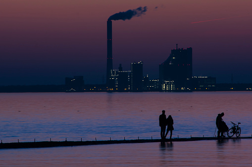 Shadow plays in front of the silhouette of Wilhelmshaven on the German North Sea.