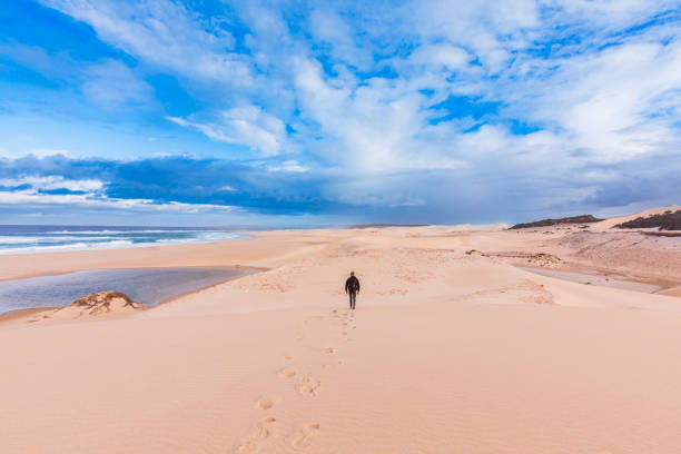 Man walking into dry arid desert coastal landscape in Western Australia