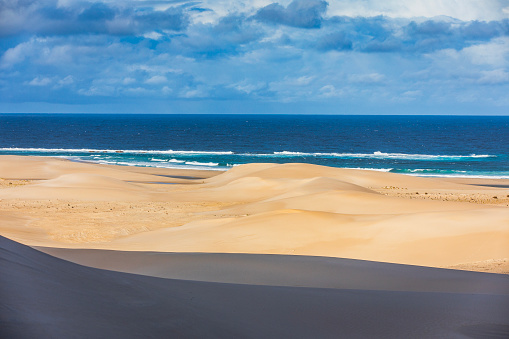 Dry arid desert landscape scene where the sand dunes meet the ocean. Photographed in Western Australia.