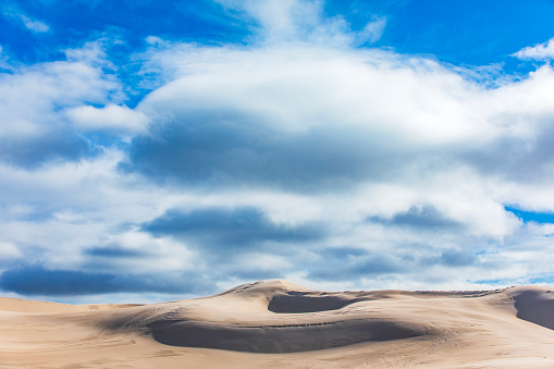 Dry arid desert landscape scene with tall untouched majestic sand dunes and blue sky in Western Australia