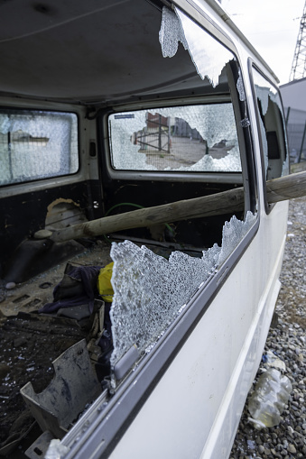 Detail of car destroyed by urban riots in the city