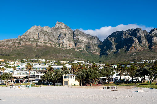 Cape Town, South Africa – December 30, 2022: A scenic beach with a stunning mountain backdrop in Camps Bay, Cape Town