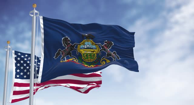 Pennsylvania state flag waving with the american flag