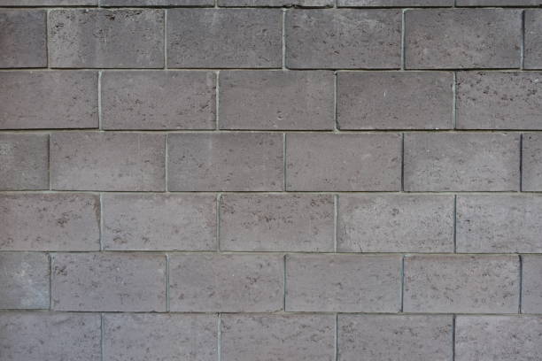 istock Backdrop - wall made of gray concrete masonry units 1994628474