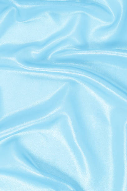 Blue shiny pearl fabric as a background. Top view.