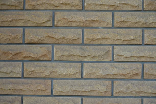 istock Dusty surface of beige brick veneer wall with grey mortar joints 1994633725