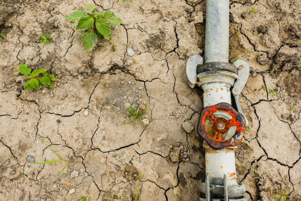 istock dried out soil with a turned off tap and only little plants due global warming 1994642738