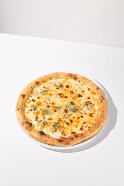 istock Italian Quattro Formaggi Pizza with Four Cheeses Isolated on White 1994644403