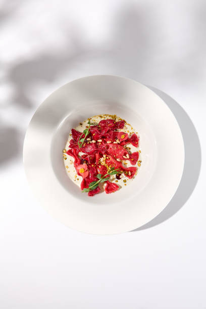 istock Beetroot Ravioli Bows in Cream Sauce, Top View with Delicate Shadow, Ideal for Artistic Food Photography 1994644451