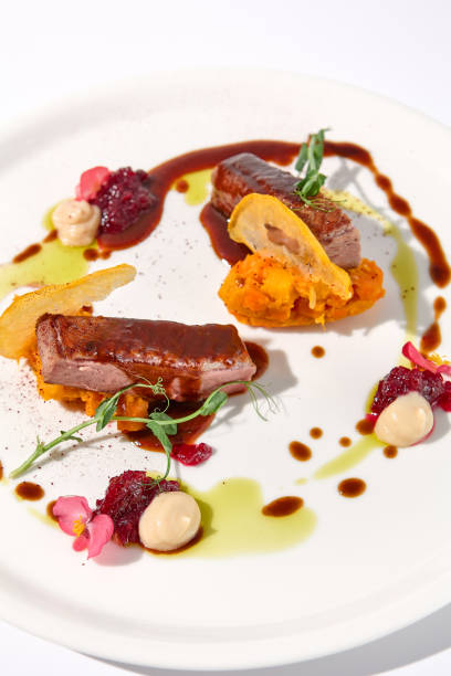 istock Duck fillet with onion marmalade and pumpkin puree, presented on a chic white plate for an upscale culinary experience 1994644967