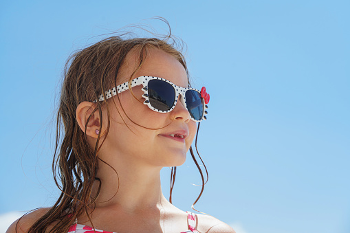 Joyful young girl on holiday at the beach looking cute