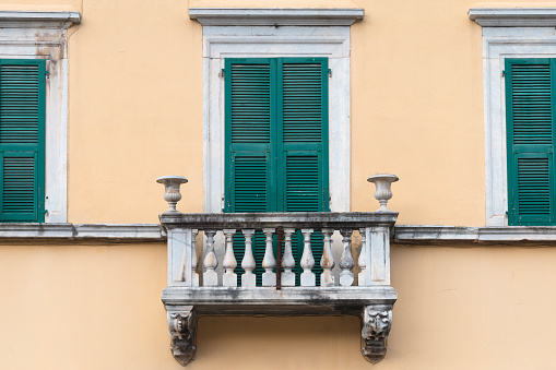 Balustrade with marble columns on the facade of a nineteenth-century Italian house