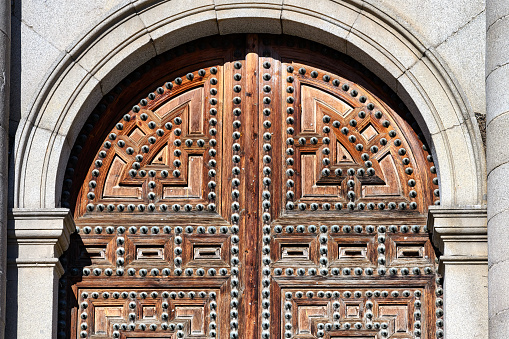 A traditional Andalusian wooden door with metal decoration.