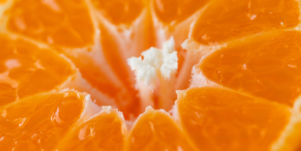 Close-up photo of a tangerine slice. Fruit background