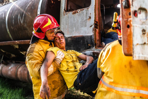 Firefighters helping a car accident victim