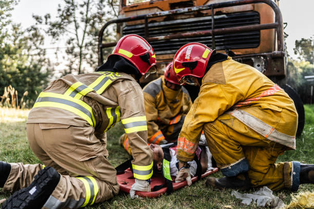 istock Firefighters helping a car accident victim 1994700413