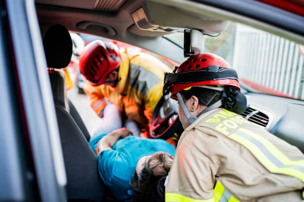 Paramedic arriving and helping victim on car accident