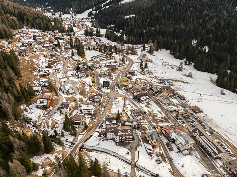 Santa Fosca Civetta resort. Panoramic view of the Dolomites mountains in winter, Italy. Ski resort in Dolomites, Italy. Aerial  drone view of Santa Fosca ski slopes and mountains in dolomites.