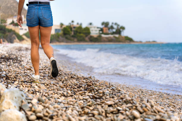 Woman walking on the beach. Time to think and disconnect from stress