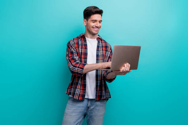 istock Photo of cheerful confident man dressed plaid shirt looking communicating apple iphone modern gadget isolated turquoise blue color background 1994753866
