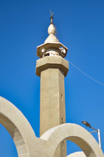 istock Minaret of a Muslim mosque over the blue sky. 1994755978