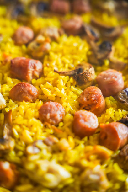 Close-up of a colorful paella with various ingredients.
