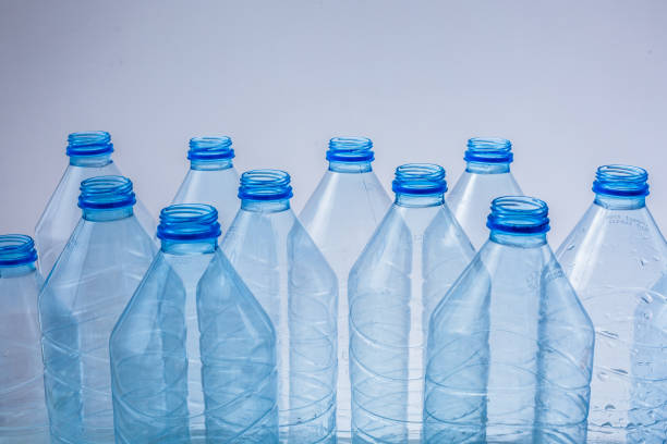 Large stack of old plastic bottles on the floor.