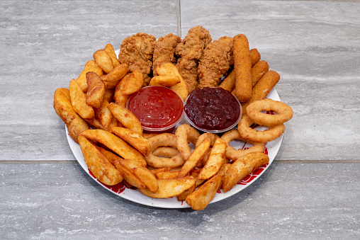 Doncaster, UK - 2019 April 8 : Mixed sides from Michelangelos Pizzeria with mozarella sticks, chicken wings, onins rings and chips or wedges