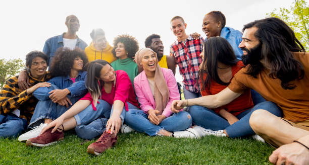 istock diverse groups of multicultural friends spending time together on the campus lawn laughing 1994831176