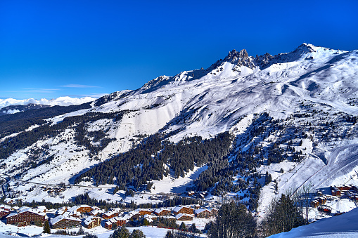 Breathtaking beautiful panoramic view on Snow Alps - snow-capped winter mountain peaks around French Alps mountains, The Three Valleys: Courchevel, Val Thorens, Meribel (Les Trois Vallees), France.