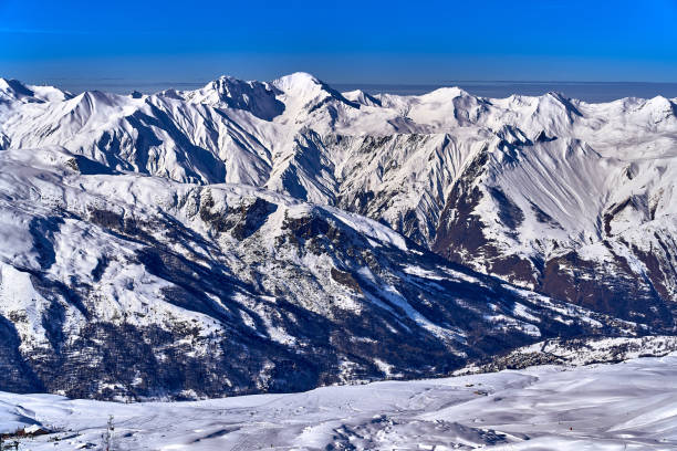 Breathtaking beautiful panoramic view on Snow Alps - snow-capped winter mountain peaks around French Alps mountains, The Three Valleys: Courchevel, Val Thorens, Meribel (Les Trois Vallees), France.