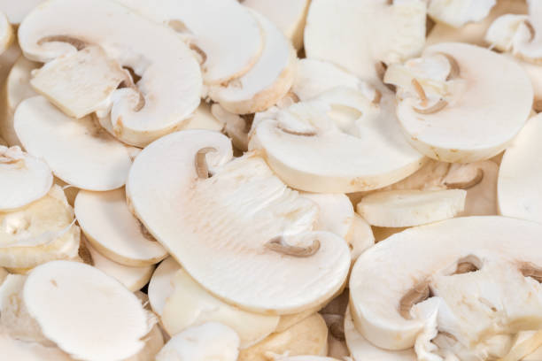 istock Raw sliced button mushrooms, close-up in selective focus 1994833849