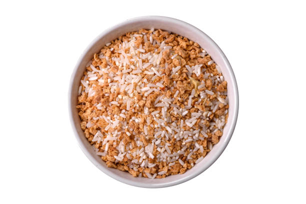 istock Large grains of uncooked white rice in a ceramic bowl 1994834907